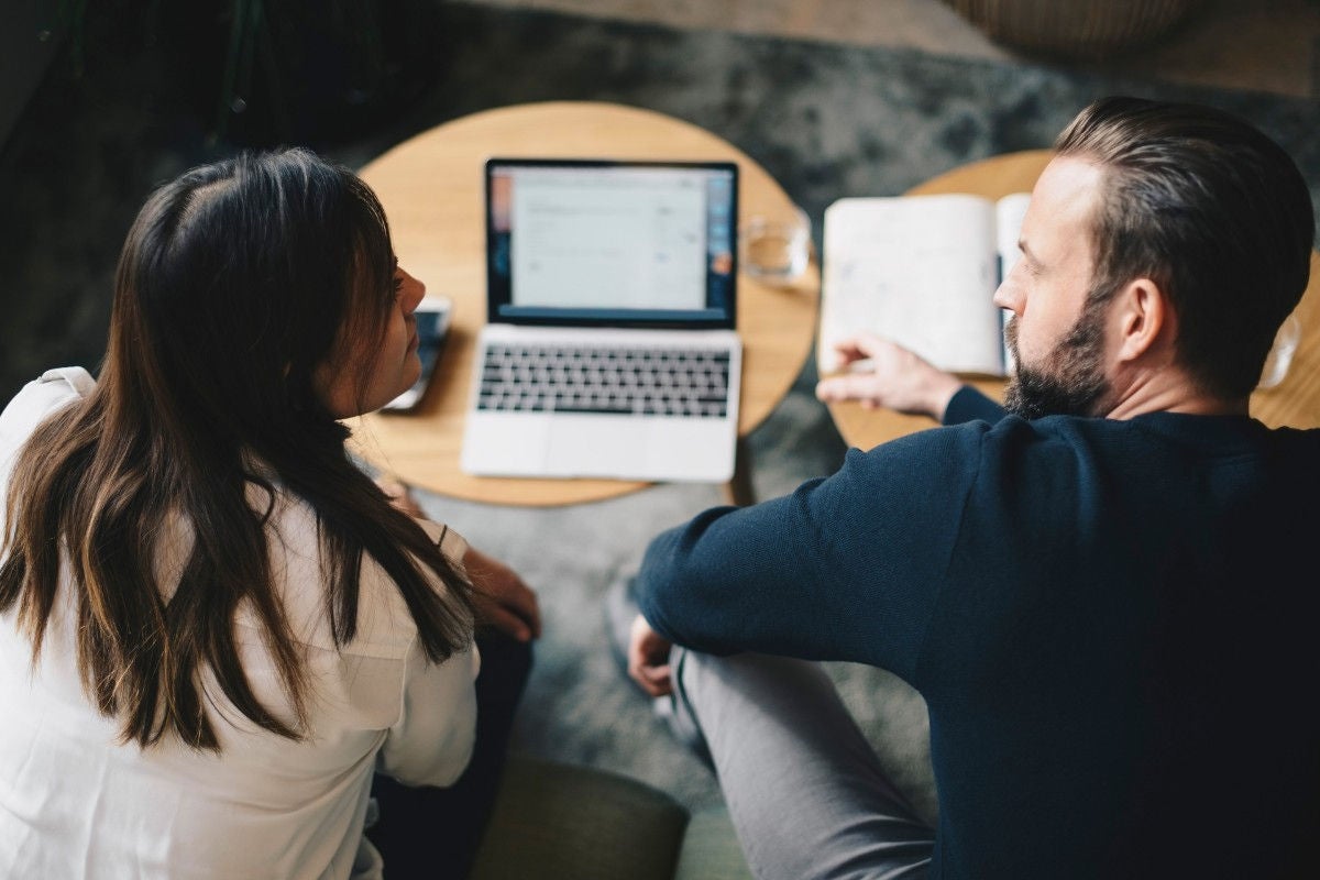 ey-woman-and-man-working-on-laptop